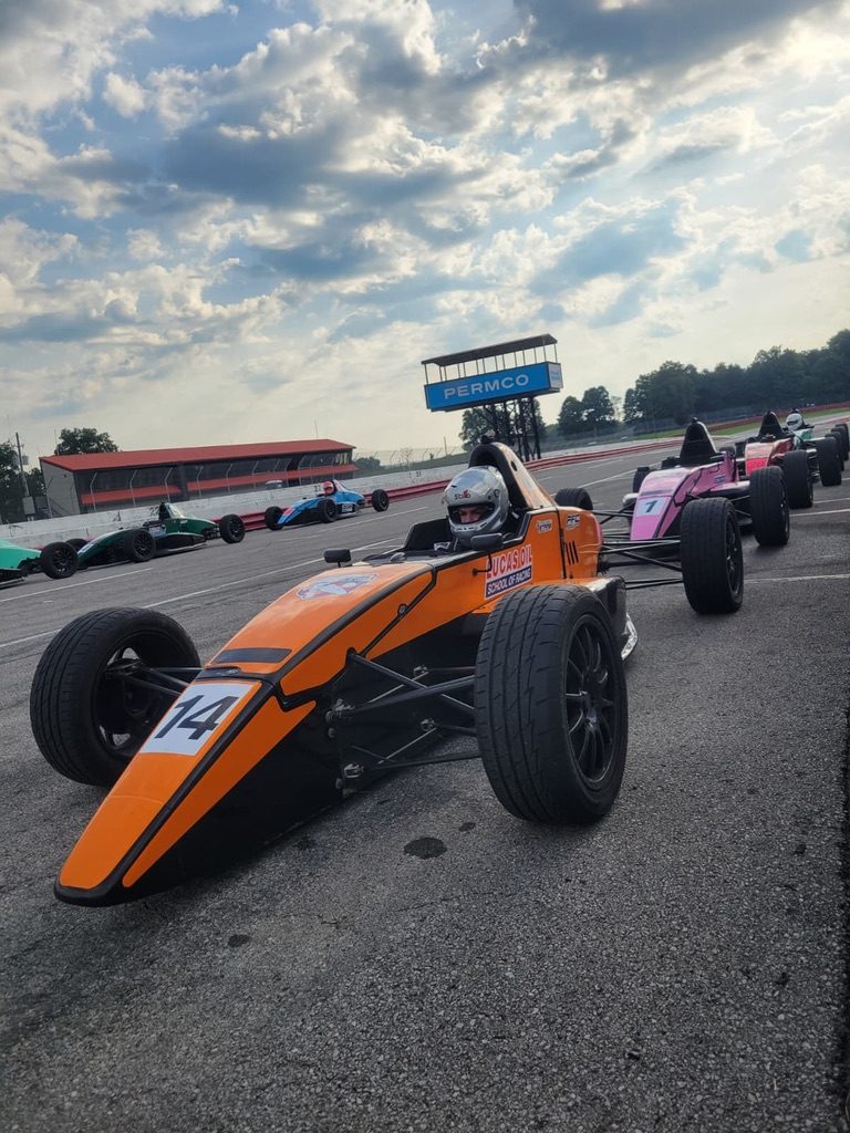 Sergio Ostos in the orange #14 Lucas Oil School of Racing car on the grid at Mid-Ohio